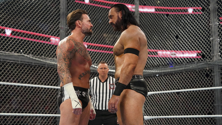 CM Punk and Drew McIntyre staring at each other inside Hell in a Cell