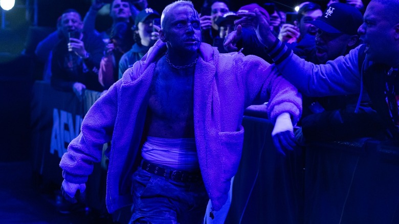 Darby Allin makes his entranced bathed in purple light.