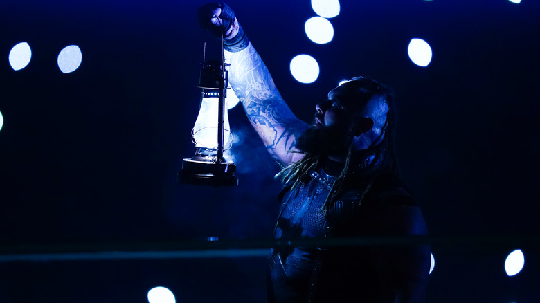 Bray Wyatt holding up his lantern