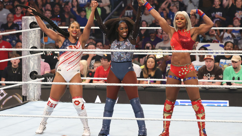 Bianca Belair, Naomi, and Jade Cargill celebrating a win