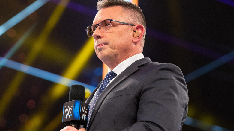 Michael Cole holding a microphone