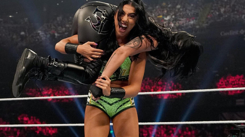 Indi Hartwell hoists up Sonya Deville in a fireman's carry.