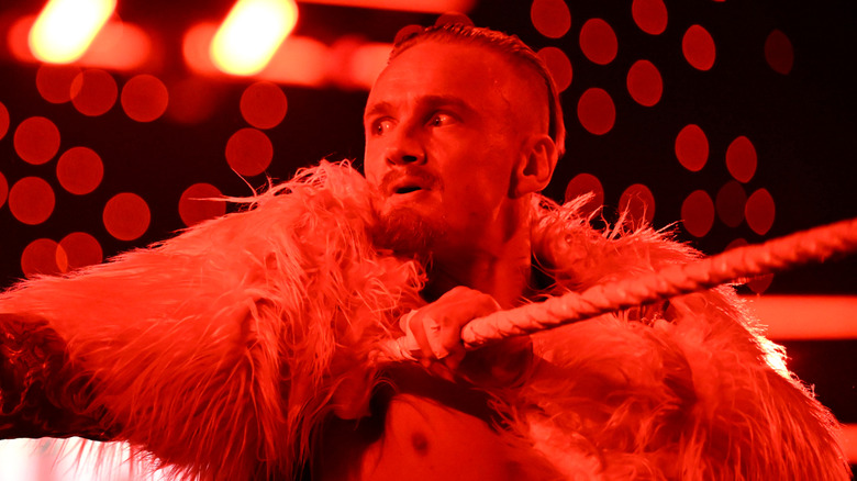 Ilja Dragunov bathed in red light in the ring