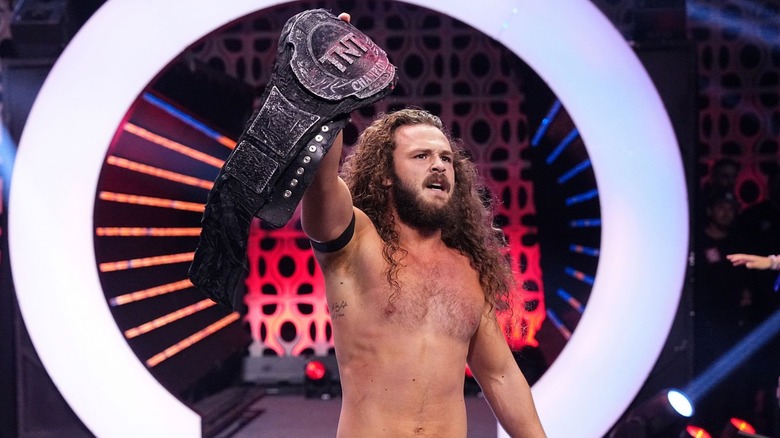 Jack Perry posing with TNT title