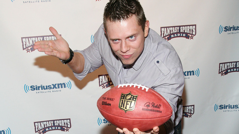 The Miz posing with a football