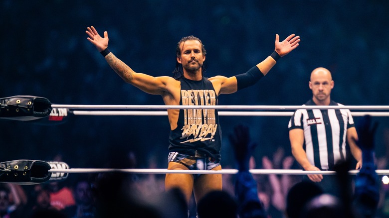 Adam Cole poses in the ring