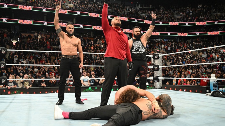 The Bloodline pose over the bodies of Jey Uso and Sami Zayn