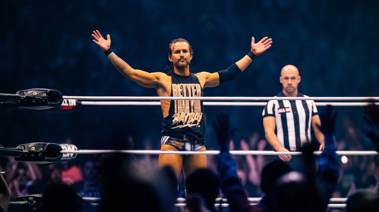 Adam Cole poses in the ring at AEW All In