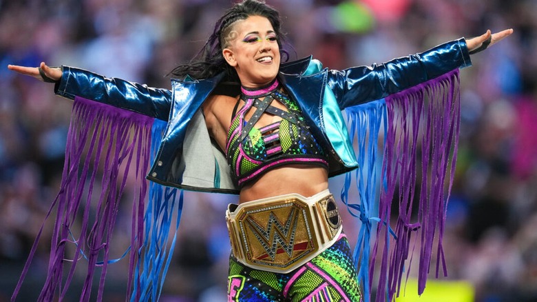 Bayley posing with her arms outstretched