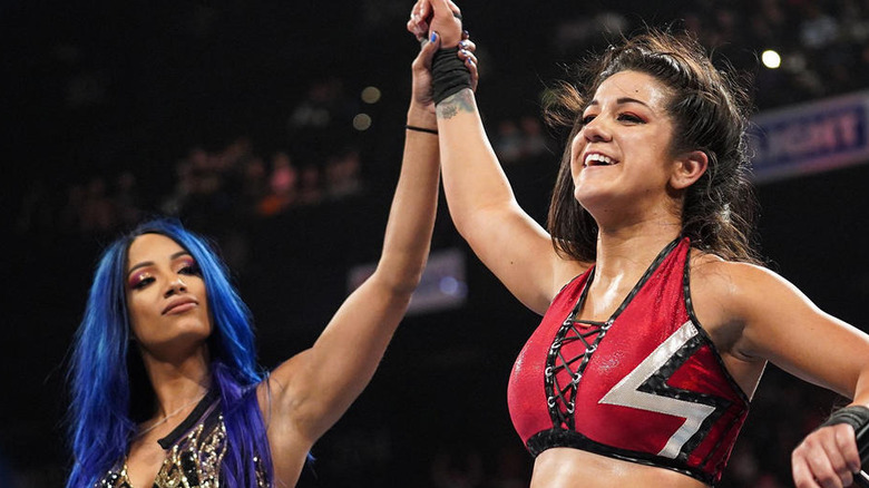 Mercedes Mone raising Bayley's arm