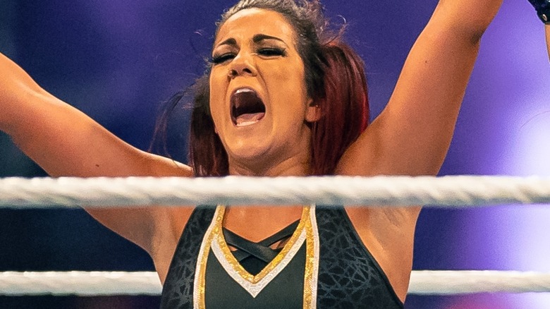 Bayley mouth open arms raised