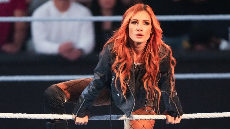 Becky Lynch hangs on the ropes during her entrance on an episode of "WWE Raw."