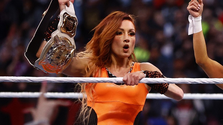 Becky Lynch posing with title 