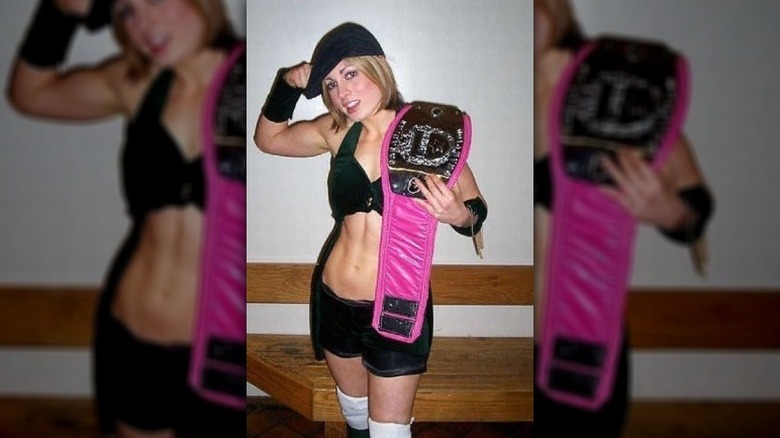 Becky Lynch holds pink belt