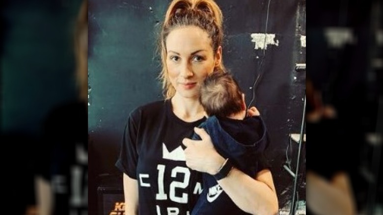 Becky Lynch holding her newborn baby