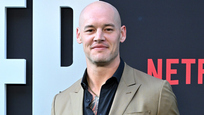 Baron Corbin wearing a beige suit jacket, with black shirt