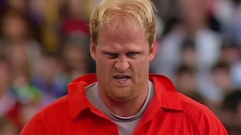 Former WWE talent Nailz appearance in front of a crowd in what appears like an orange prison jumpsuit during an episode of WWE programming.