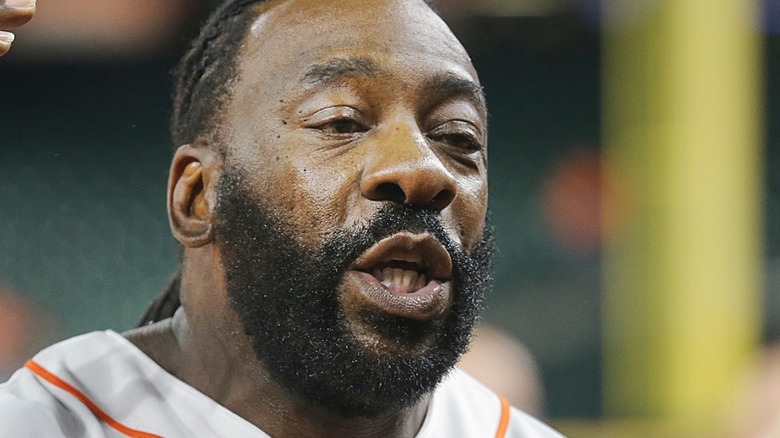 Booker T speaks to the media at a baseball game