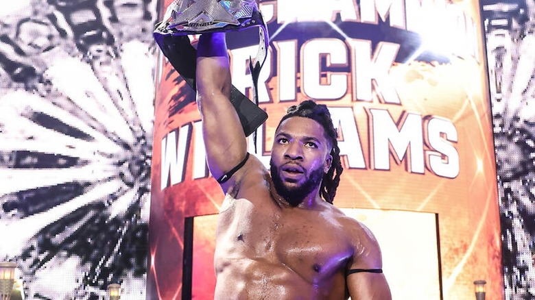 Trick Williams raises the NXT Championship.