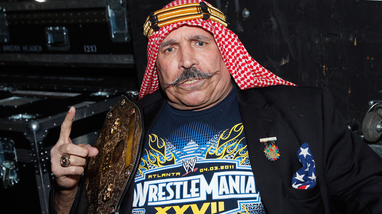 The Iron Sheik holding championship belt