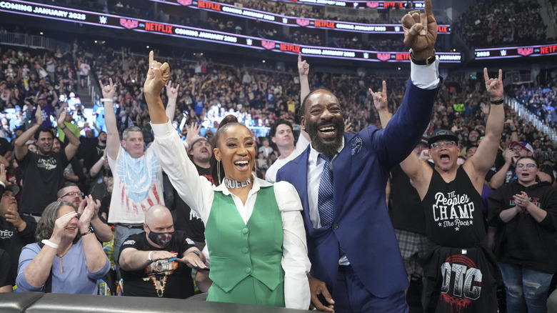 Booker T holds up a pinky alongside his wife Sharmell