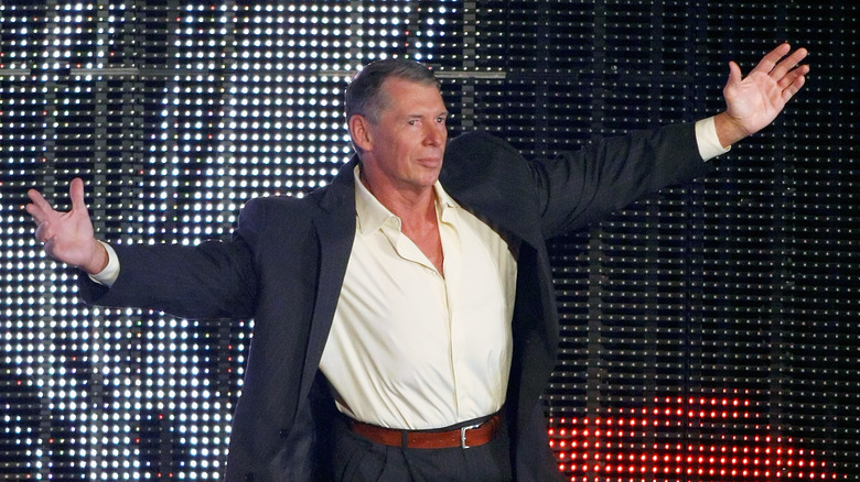 Vince McMahon extends arms