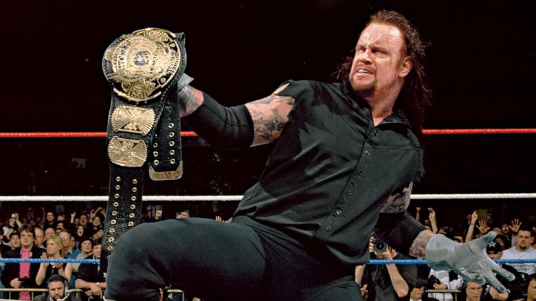 The Undertaker posing with a title