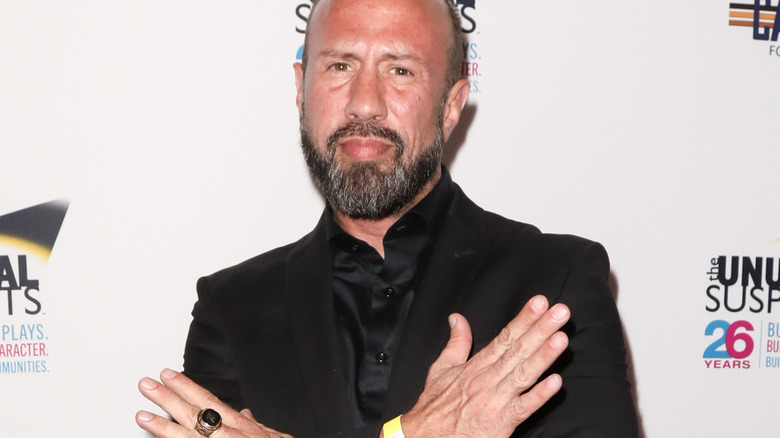 Sean Waltman makes the D-Generation X symbol during a red carpet event.