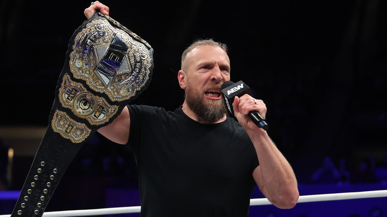 Bryan Danielson holding up AEW title belt