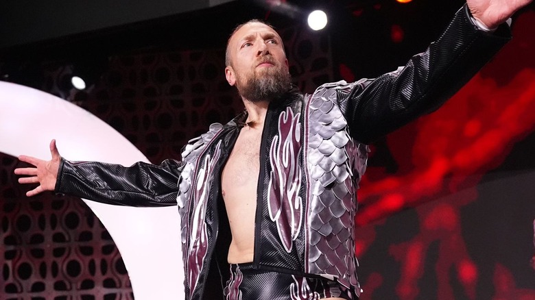 Bryan Danielson wearing a black and silver jacket