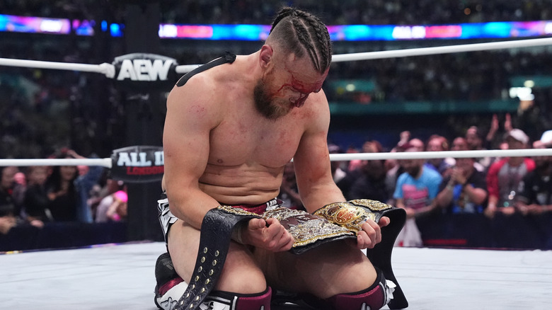 Bryan Danielson celebrates with the AEW World Title