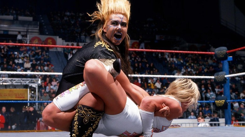Bull Nakano puts Madusa in a submission hold