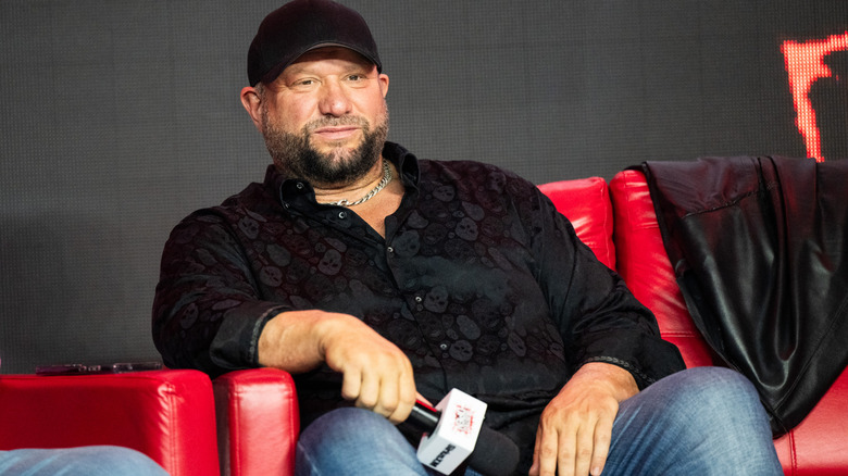 Bully Ray sitting down and holding a microphone