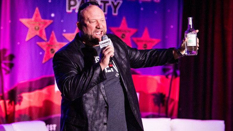 Bully Ray brandishing a bottle of tequila as he speaks