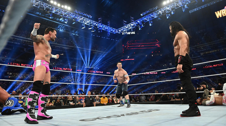 CM Punk, Seth Rollins, and Roman Reigns in the ring