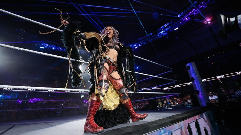 Giulia stands on the ring apron and gives a quick pose before her title shot