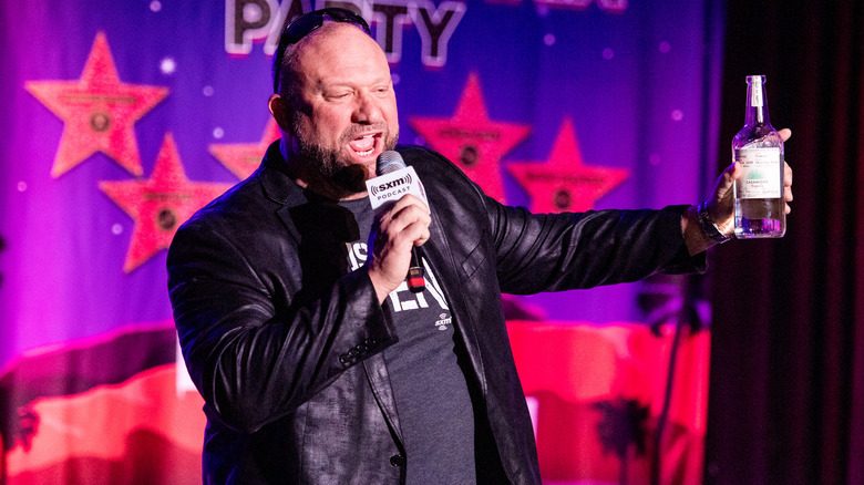 Bully Ray brandishing a bottle of tequila as he speaks