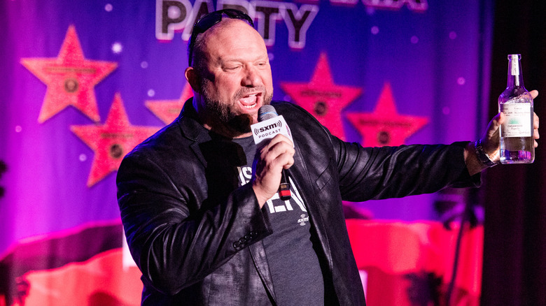 Bully Ray brandishing a bottle of tequila as he speaks