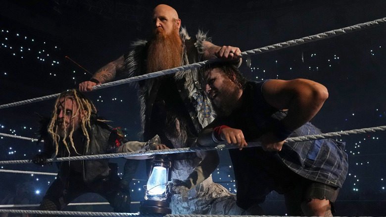 Rowan, Joe Gacy, and Dexter Lumis pose in the ring