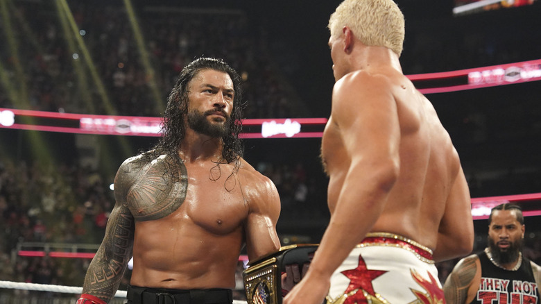 Roman Reigns gives Cody Rhodes his title during Bad Blood