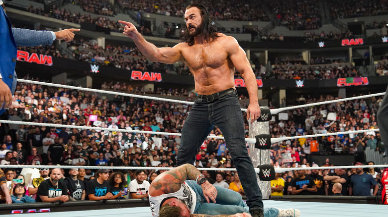 Drew McIntyre stands over a battered CM Punk