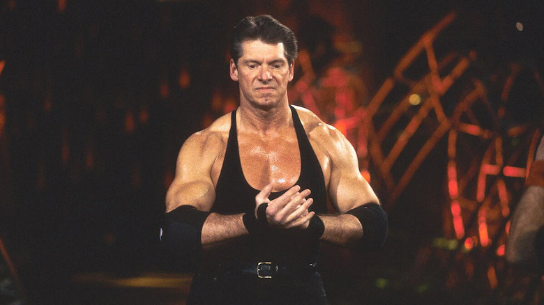 A pumped Vince McMahon walks to the ring