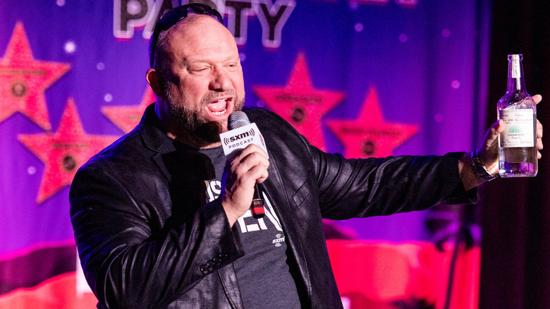 Bully Ray brandishing a bottle of tequila as he speaks