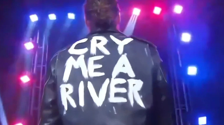 Jack Perry wears a black leather jacket with "cry me a river" painted