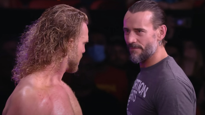 "Hangman" Adam Page and CM Punk stare each other down.