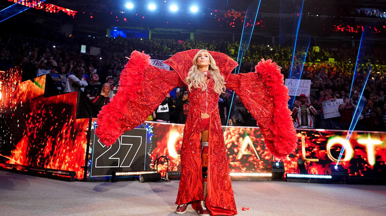 Charlotte Flair makes her 2025 Royal Rumble entrance, cloaked in an elaborate red cloak.