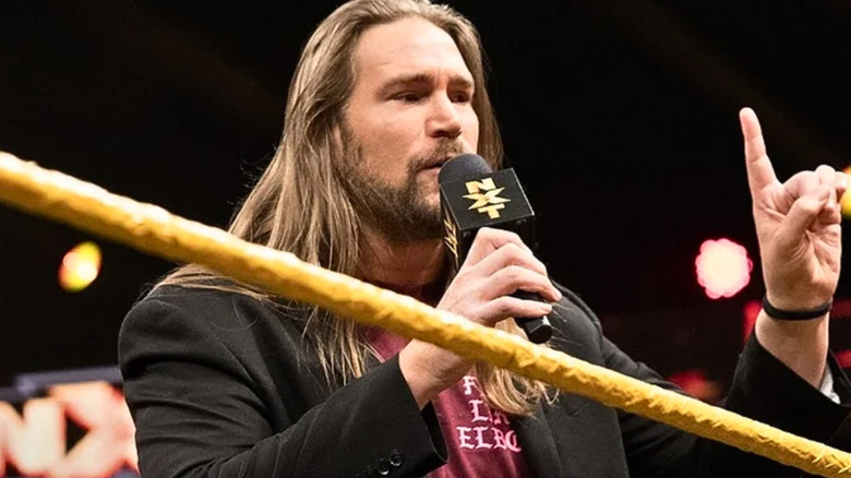 Chris Hero talking into a microphone