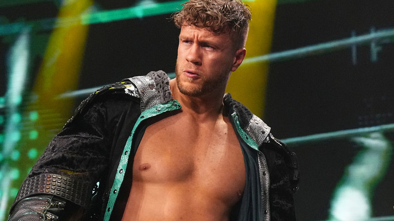 Will Ospreay wearing a black and green ring jacket