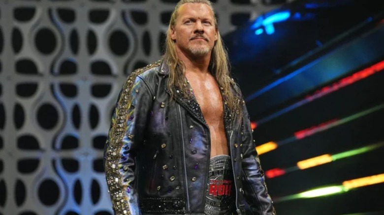 Chris Jericho walks to the ring wearing the ROH Championship around his waist during a match on AEW programming.