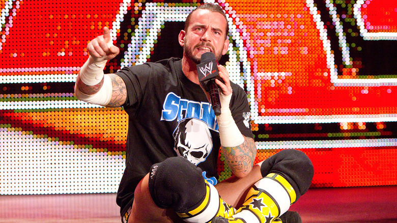 CM Punk sitting crosslegged at the top of the entrance ramp on WWE Raw